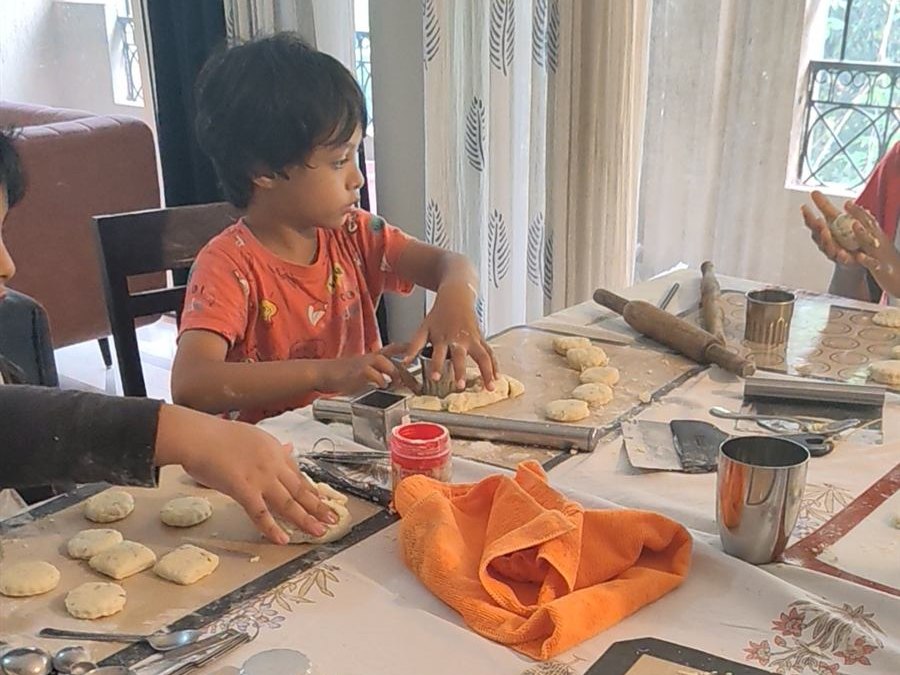 Kids baking together at a table during a Baking Fridays session